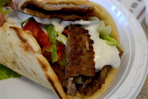 Yummy gyro - The Yummy Gyro Combo Sandwich features a delicious combination of thinly sliced seasoned beef and lamb, served on a warm pita with lettuce, tomatoes, onions, and a tangy tzatziki sauce. This sandwich is a mouthwatering treat for any gyro lover, offering a perfect balance of savory meat and fresh toppings.